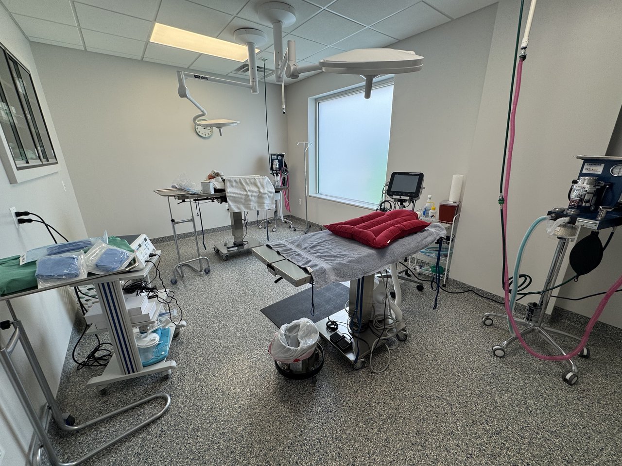 Surgical suite with two surgical tables, anesthesia, and electric cautery setup
